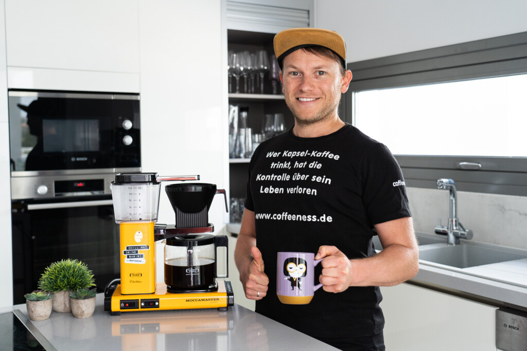 Arne posing next to his beloved yellow Moccamaster.