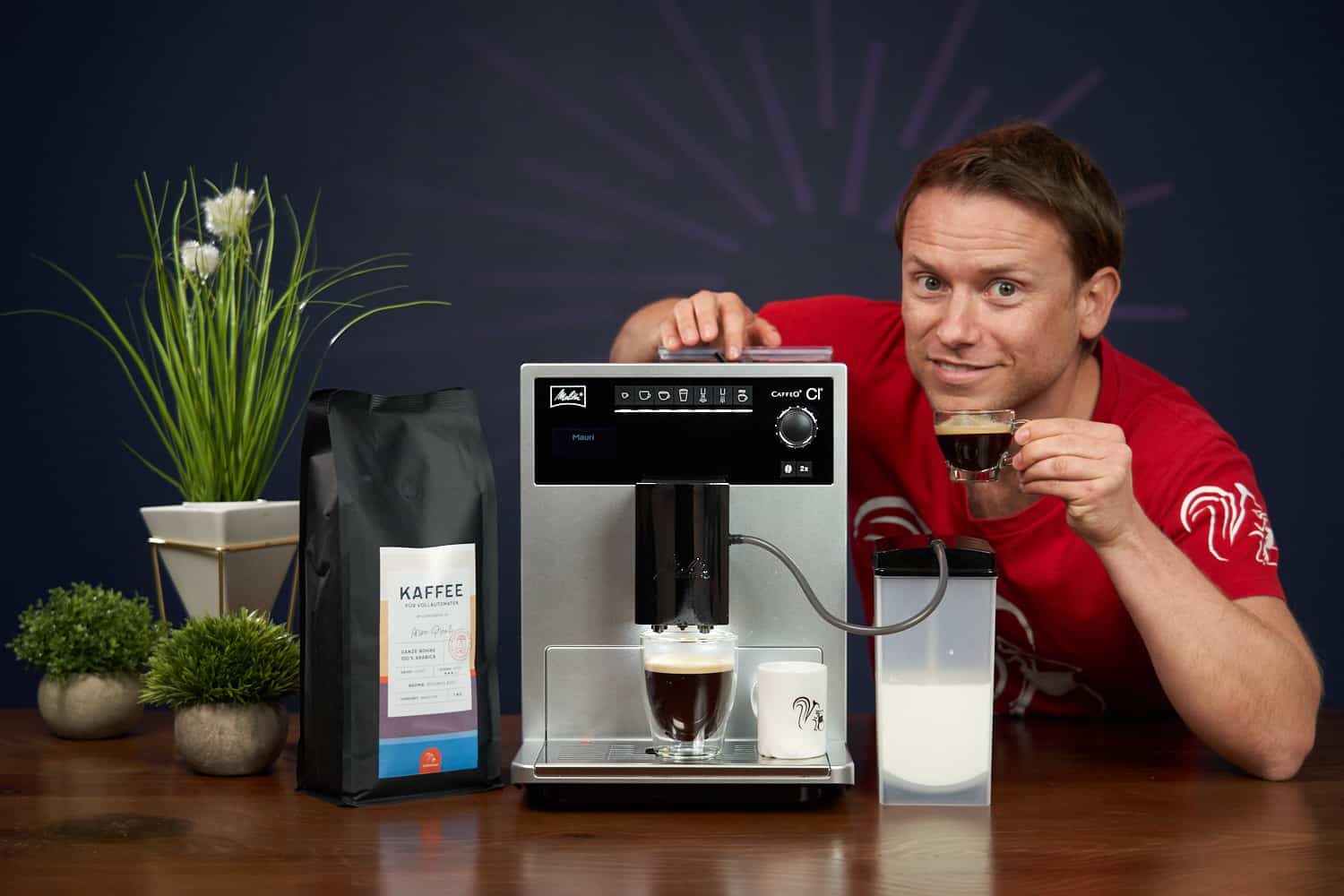 Arne posa con la cafetera superautomática Melitta Caffeo CI y un expreso preparado con el café de Coffeeness