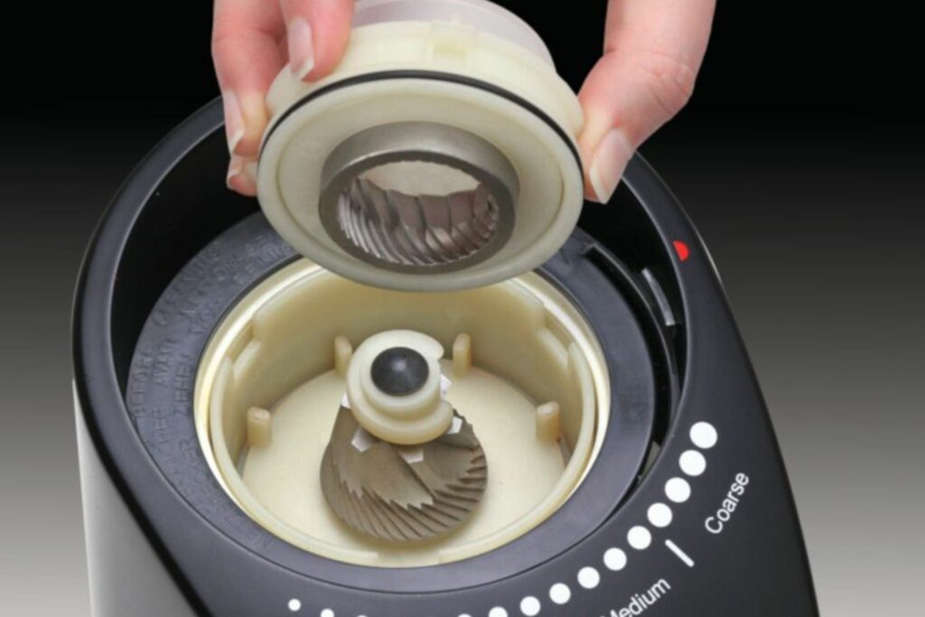 Closeup of the Capresso Infinity Plus stainless steel conical burrs.