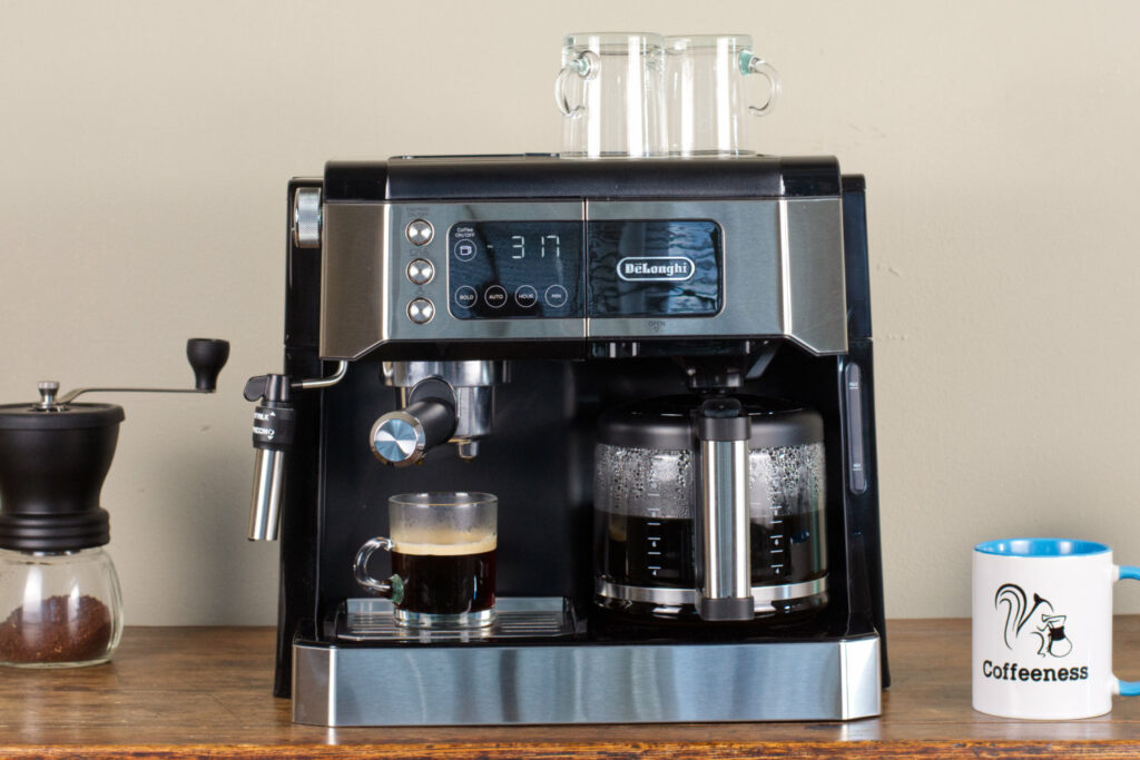 The DeLonghi All in One with a pot of coffee and a freshly made espresso.