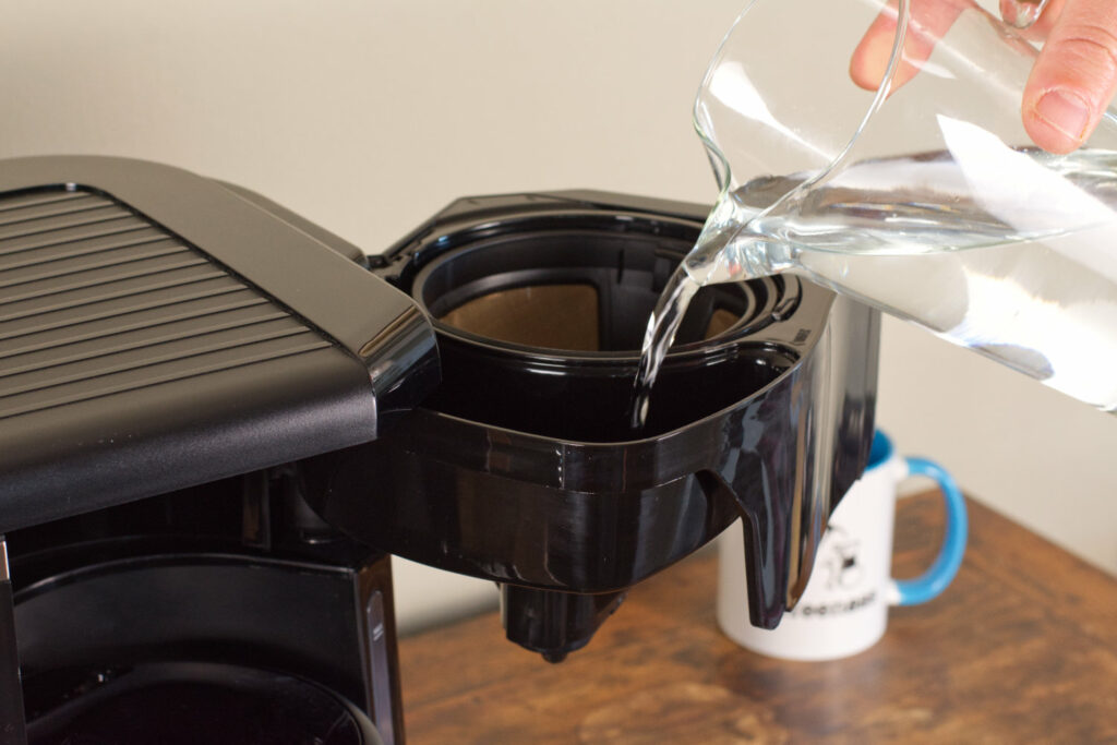 Adding water to the DeLonghi All in One.