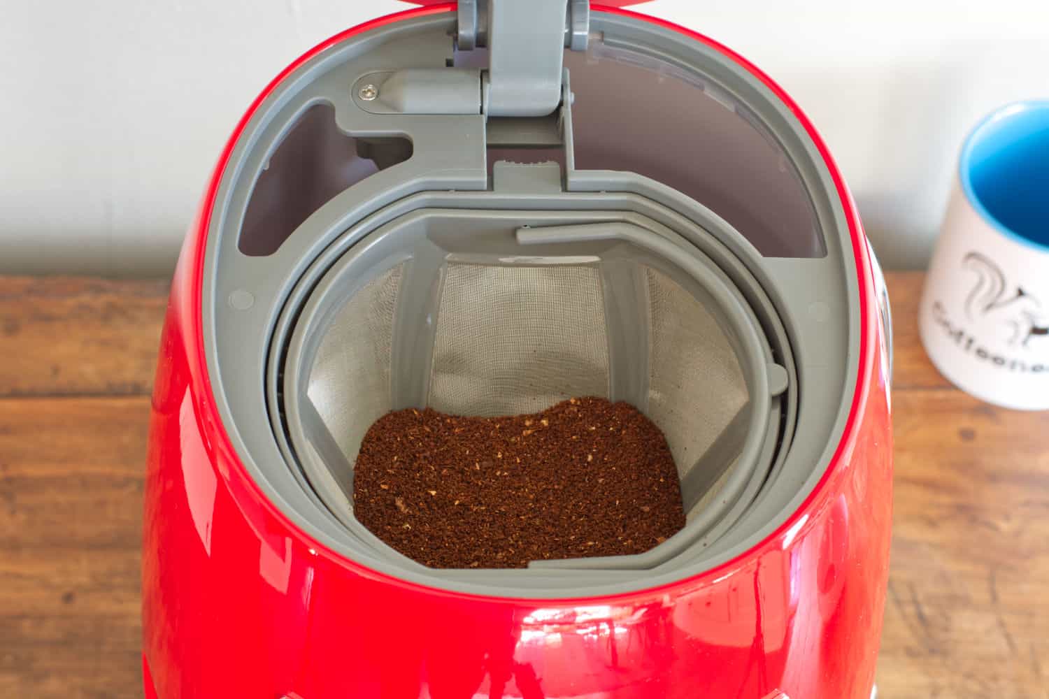 Overhead view of the SMEG Coffee Maker with coffee grounds in the filter.