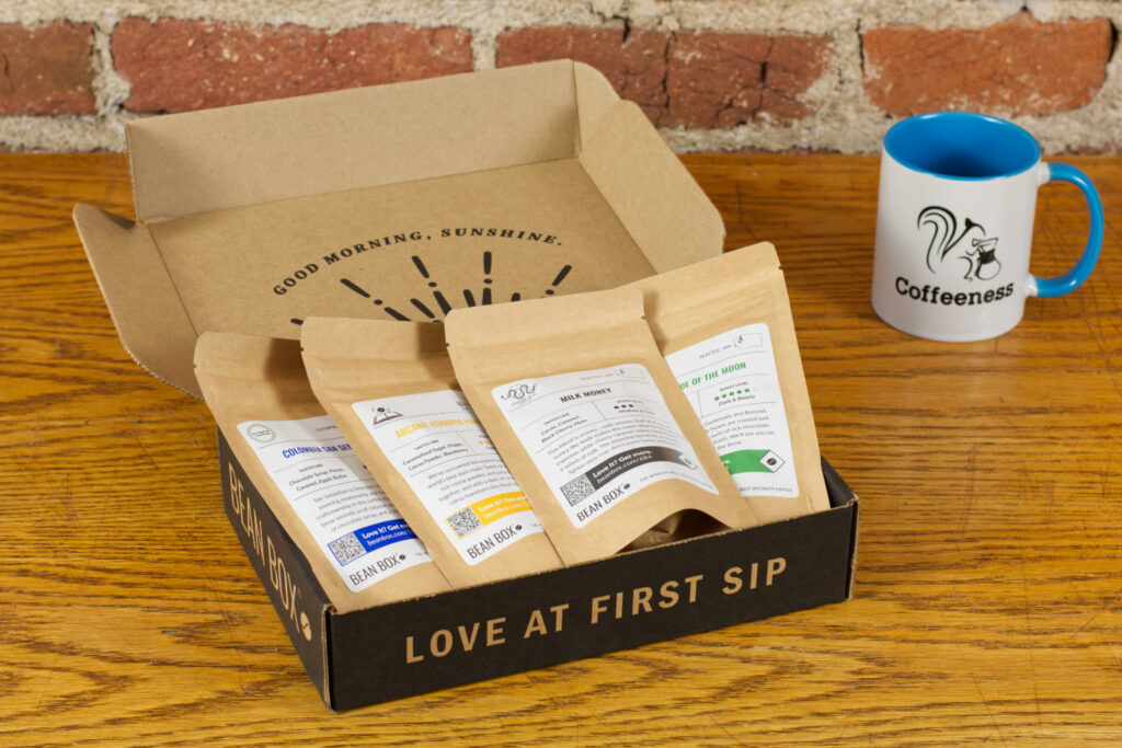Bean Box coffee sampler next to a Coffeeness mug.