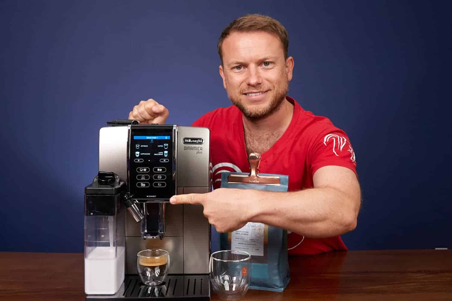 Arne pose avec la DeLonghi Dinamica Plus ECAM 372.95.TB et un espresso fraîchement préparé.